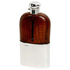 An extremely  large unused 1920s crocodile, silver and glass drinks flask.