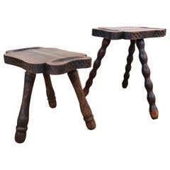 Pair of brutalist oak tripod milking stools.