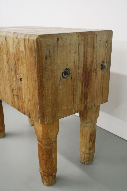 18th century solid butcher block table, France. Extremely thick wood block on carved wooden legs, with cool industrial metal bolts on sides for support. All original. Perfect for that little nook in any kitchen!

14.5