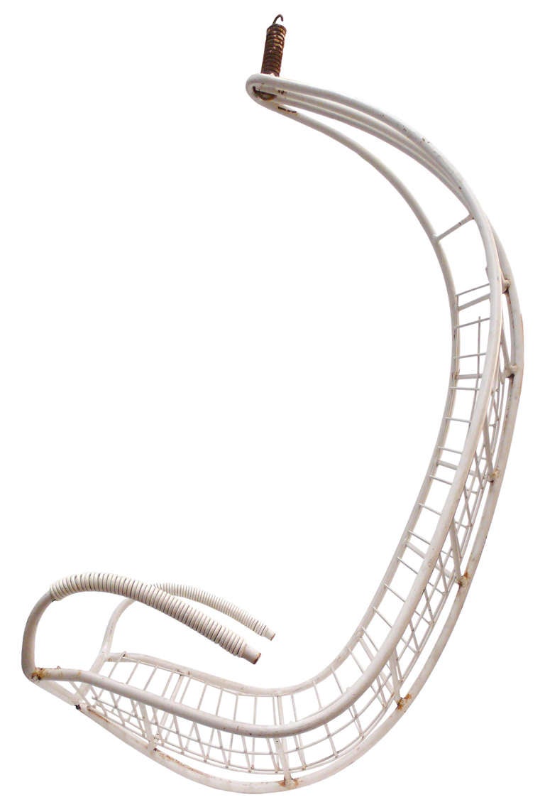 A wonderful and unusual metal hanging lounge chair. Interesting bone-like frame with beautifully curving, sculptural and cord-wrapped arms and it's original hanging-spring. An extremely cool example of California Modern outdoor seating which could