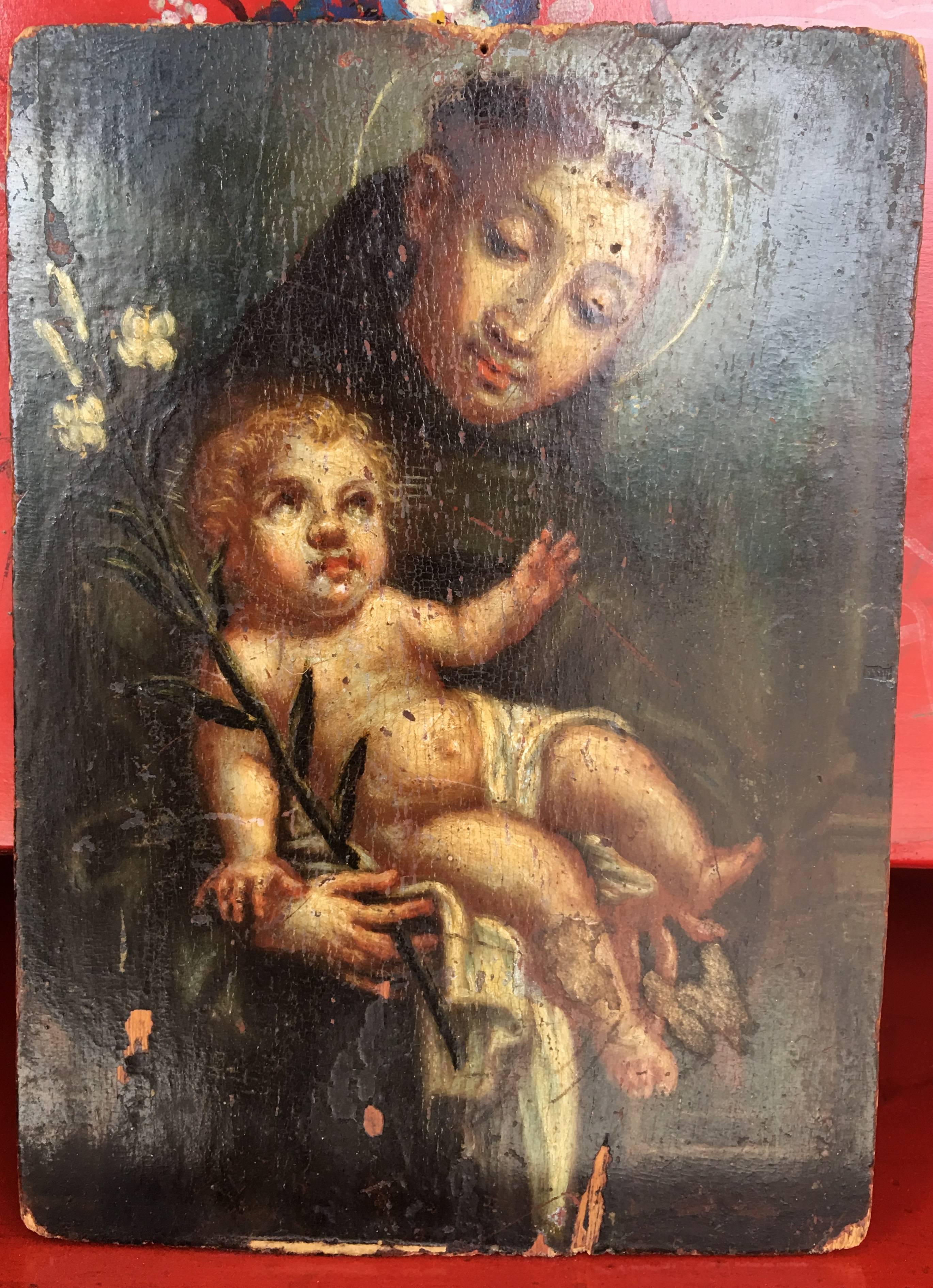 Olio originale su tavola raffigurante il Santo che offre il Bambino, opera di un artista non identificato.

--Questo quadro rappresenta Sant'Antonio da Padova.  La scena è quella che viene spesso scelta per rappresentarlo: un giorno i suoi