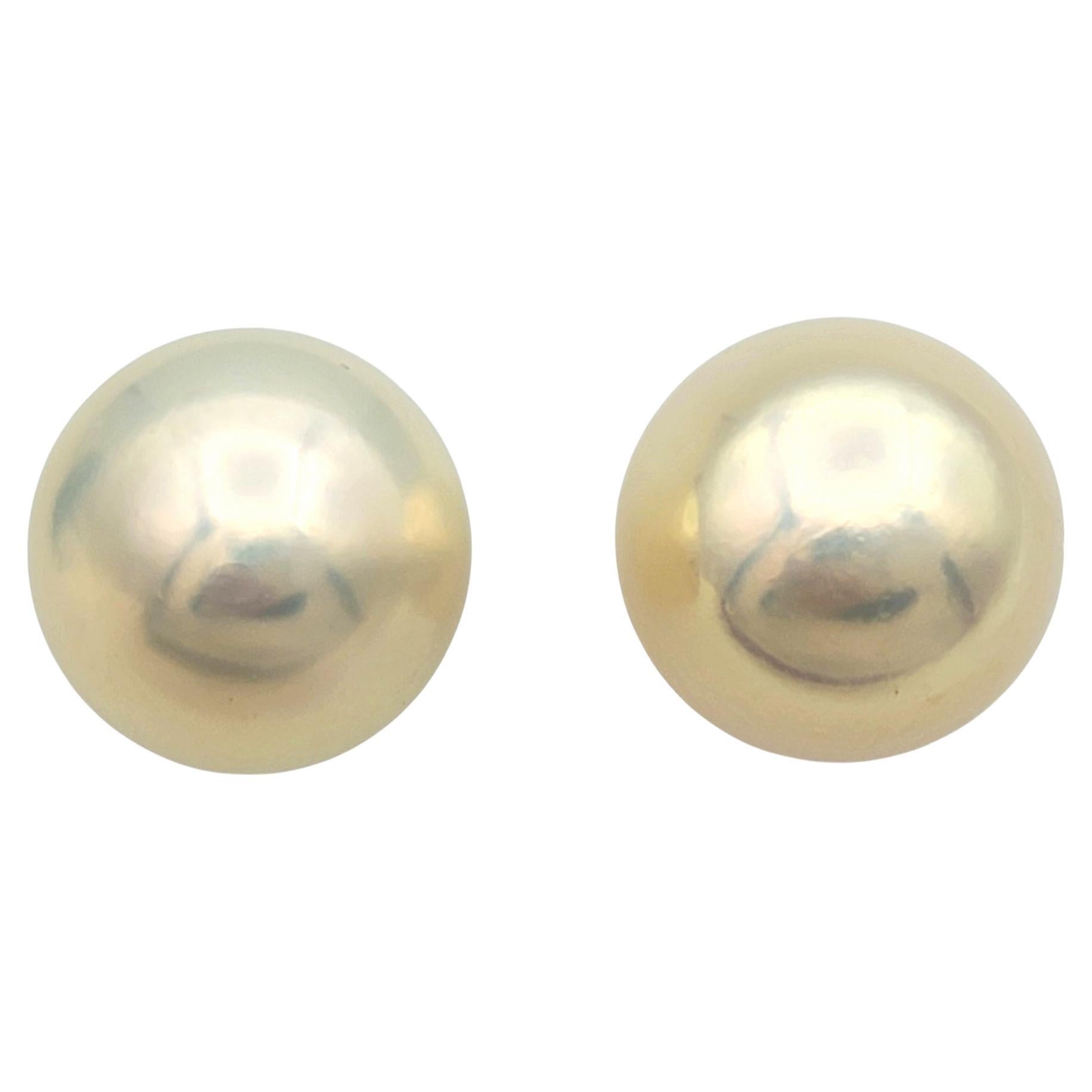 Elevate your style with these enchanting pearl stud earrings, a perfect blend of timeless elegance and modern refinement. The cultured freshwater pearls feature a soft off-white hue, beautifully enhanced by a delicate rosé overtone that radiates a