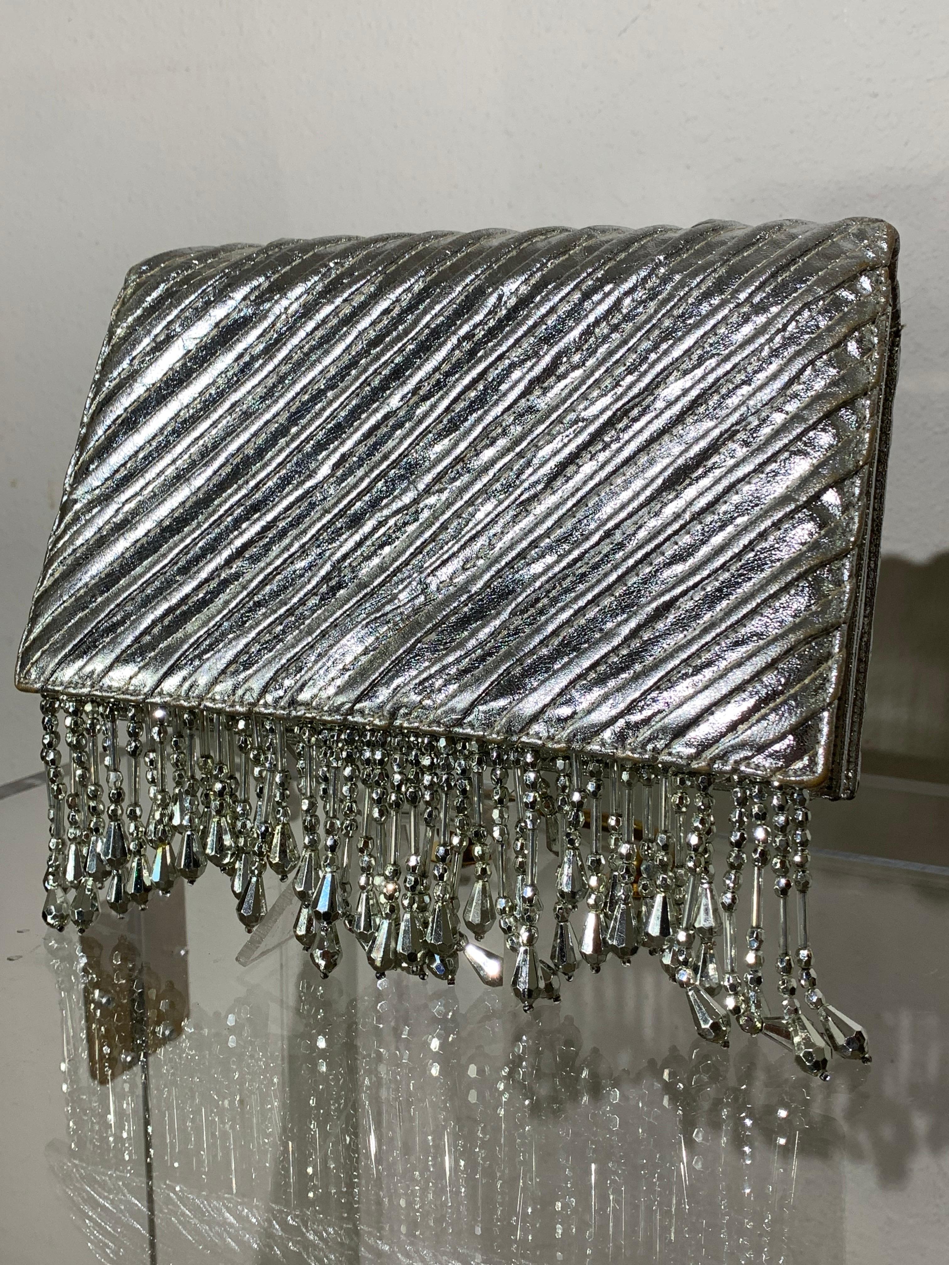 Custom-Made Silver Quilted Metallic Leather Envelope Clutch w/ Silver Bead Fringe:  A fabulously over-the-top statement clutch makes quite an entrance!  Snap closure. Lined in cream with fine embroidered flower appliques. Slit pocket inside. Plenty