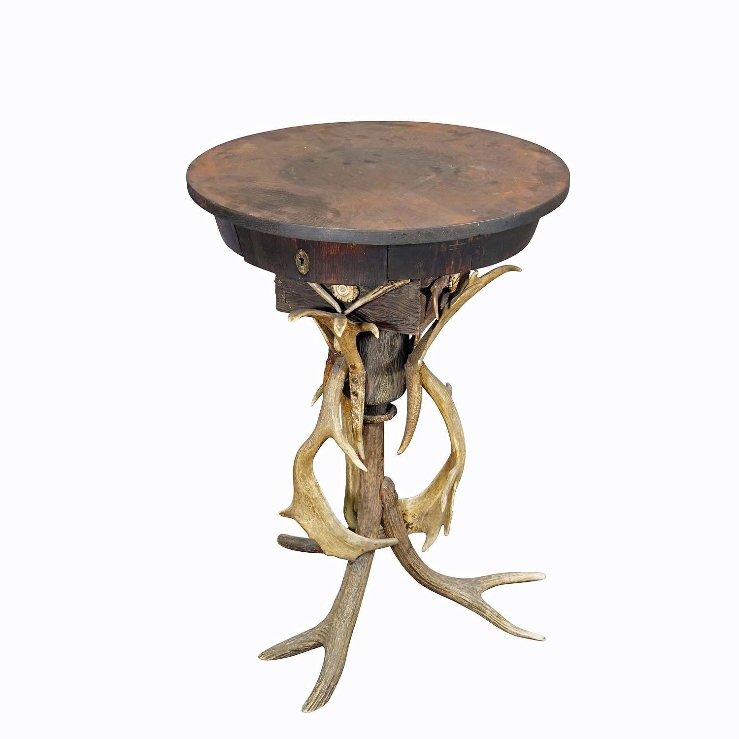 Elaborate Handmade Black Forest Style Antler Side Table ca. 1900

An elaborately hand-made Black Forest style side table. It is made of antlers from the deer and fallow deer and an oak wood table top with drawer. Key is missing. Germany - Black