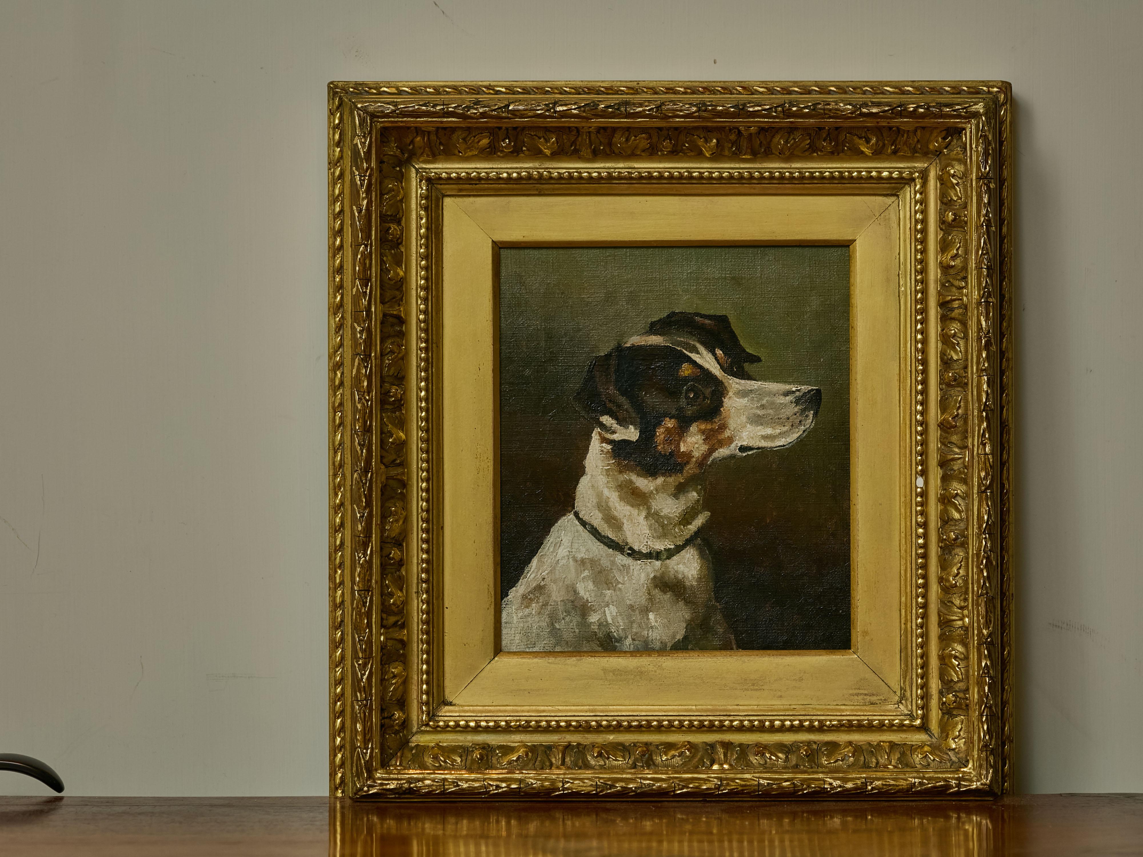 An English oil on canvas painting of a terrier dog head from the 19th century in carved gilded frame. This endearing English oil on canvas painting from the 19th century captures the expressive head of a terrier dog, rendered with remarkable