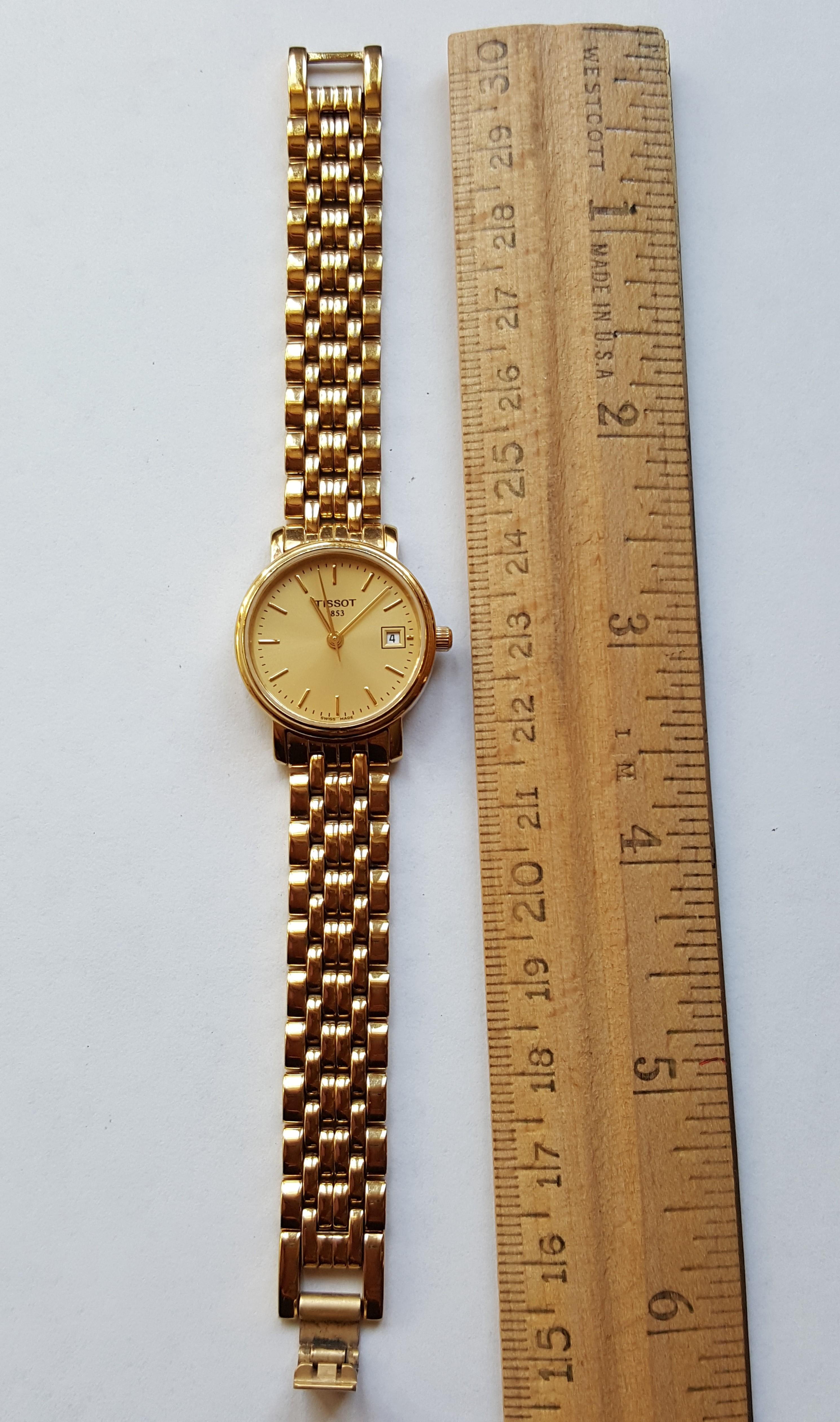 Ladies gold plated Tissot watch in good condition. 24 mm case width, and 6 mm case thickness, water resistant up to 30mm, date window. The bracelet 2.5 inches long on each side. The back of the watch is engraved with 1825/925 TKR-BC 34734 30mm water