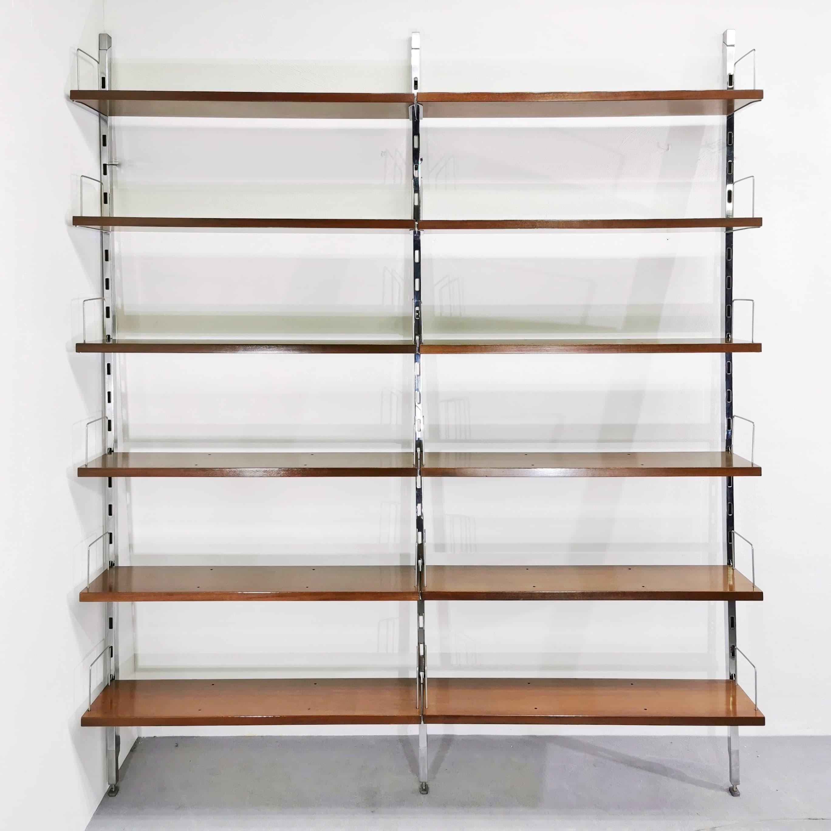 Elegant MiM Ico Parisi wall-mounted bookcase in teak and polished steel. It is a wall system bookcase composed of 12 teak shelves with polished steel hooks and 3 polished steel perforated uprights. The Bookcase requires anchoring to the wall. The