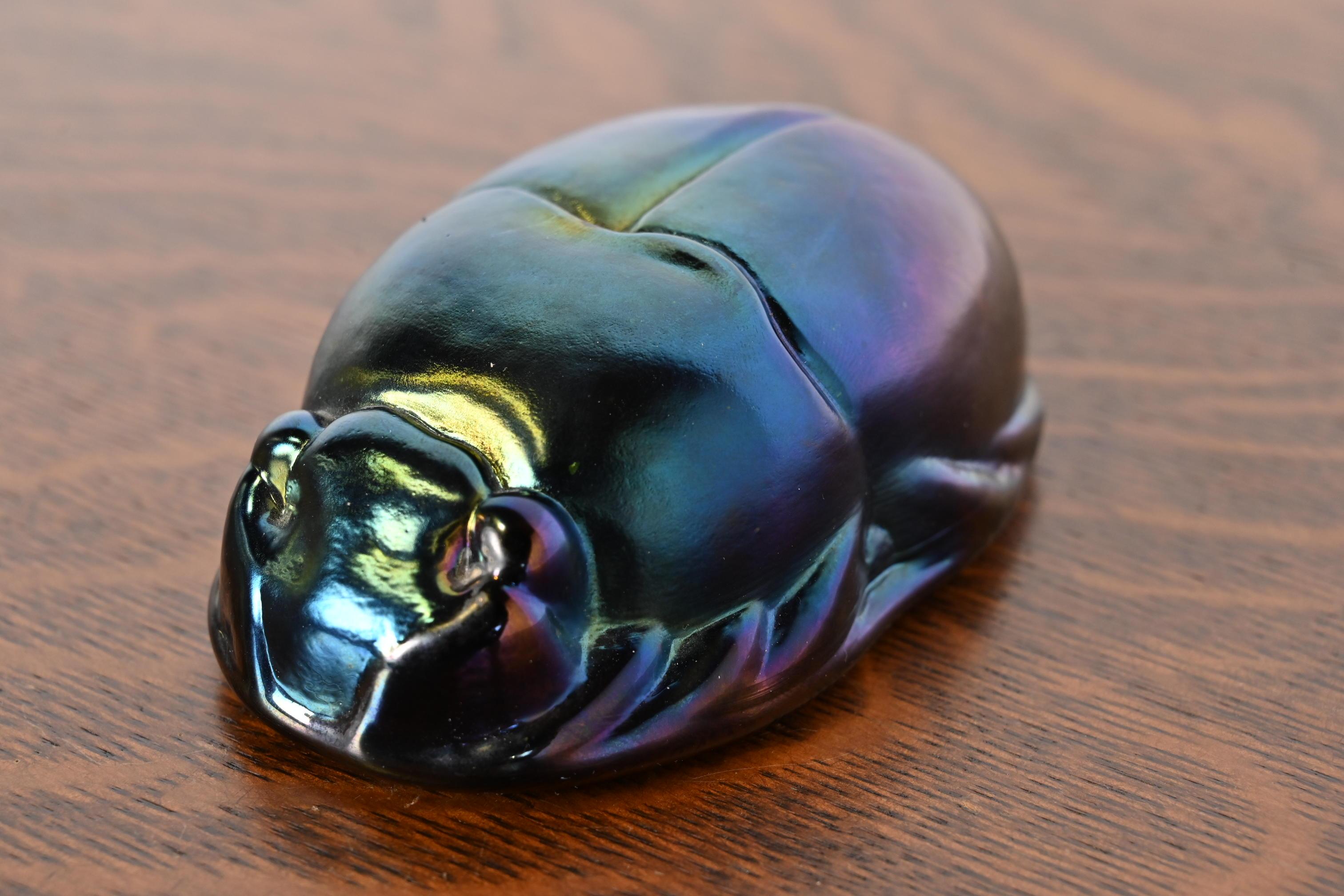 A gorgeous Arts & Crafts or Art Deco style iridescent favrile glass scarab paper weight

In the manner of Tiffany Studios

USA, 20th Century

Measures: 4.63