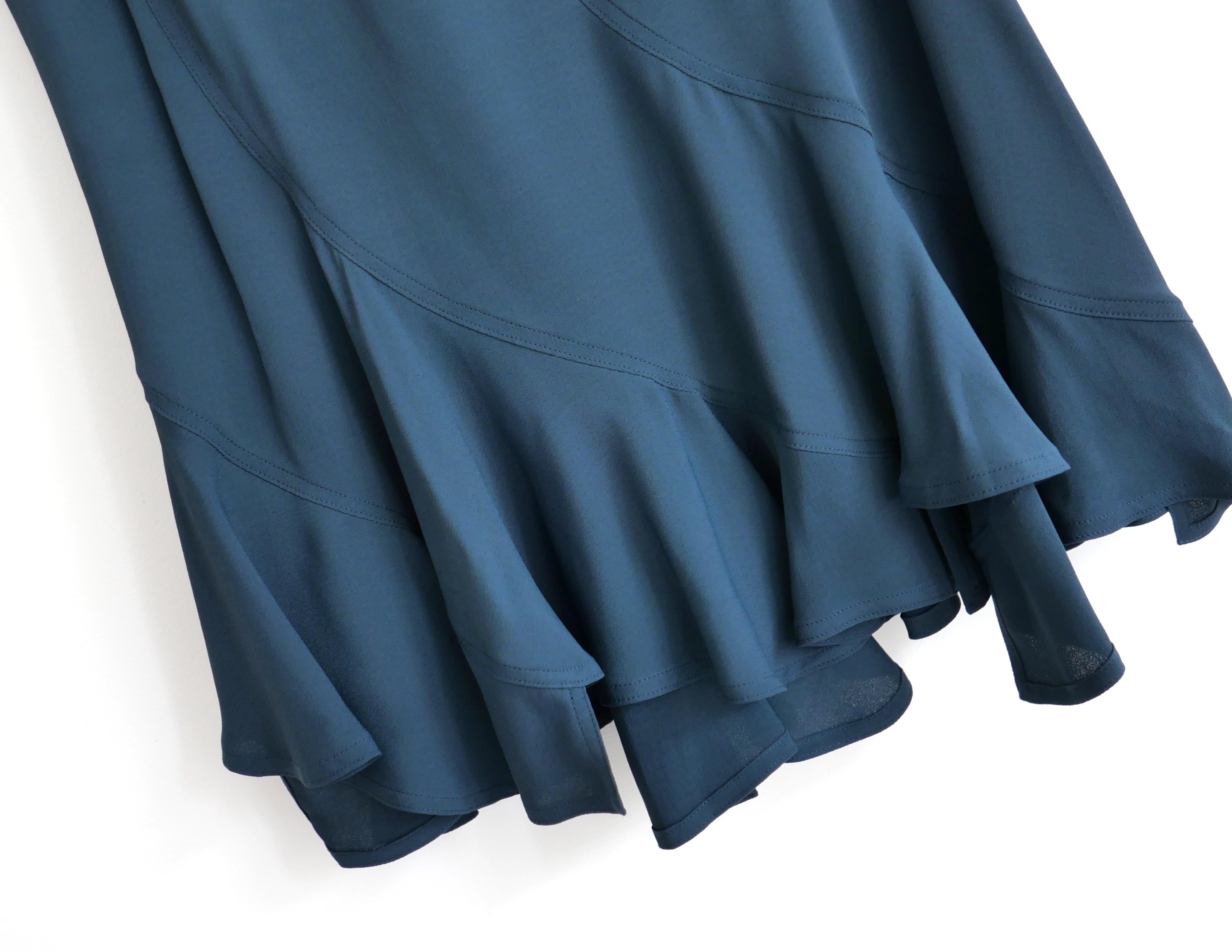 Super collectible vintage Yves Saint Laurent x Tom Ford Skirt. From the Fall 2003 collection. Unworn. Made from super fluid petrol blue viscose crepe, it has a gorgeous bias cut panelled construction with frilled hem, grow on waist and zip back with