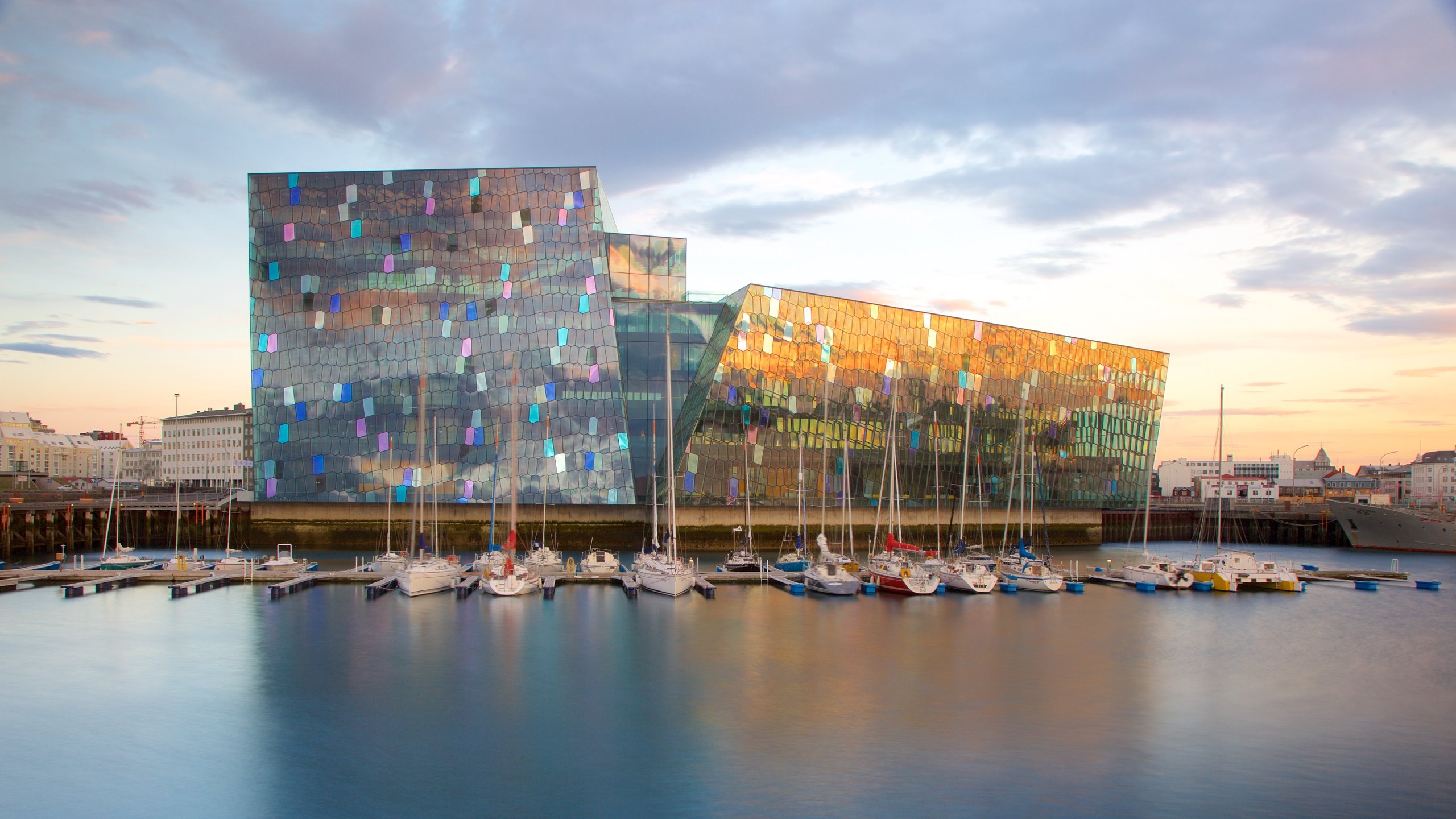 Harpa featuring a sunset, general coastal views and modern architecture