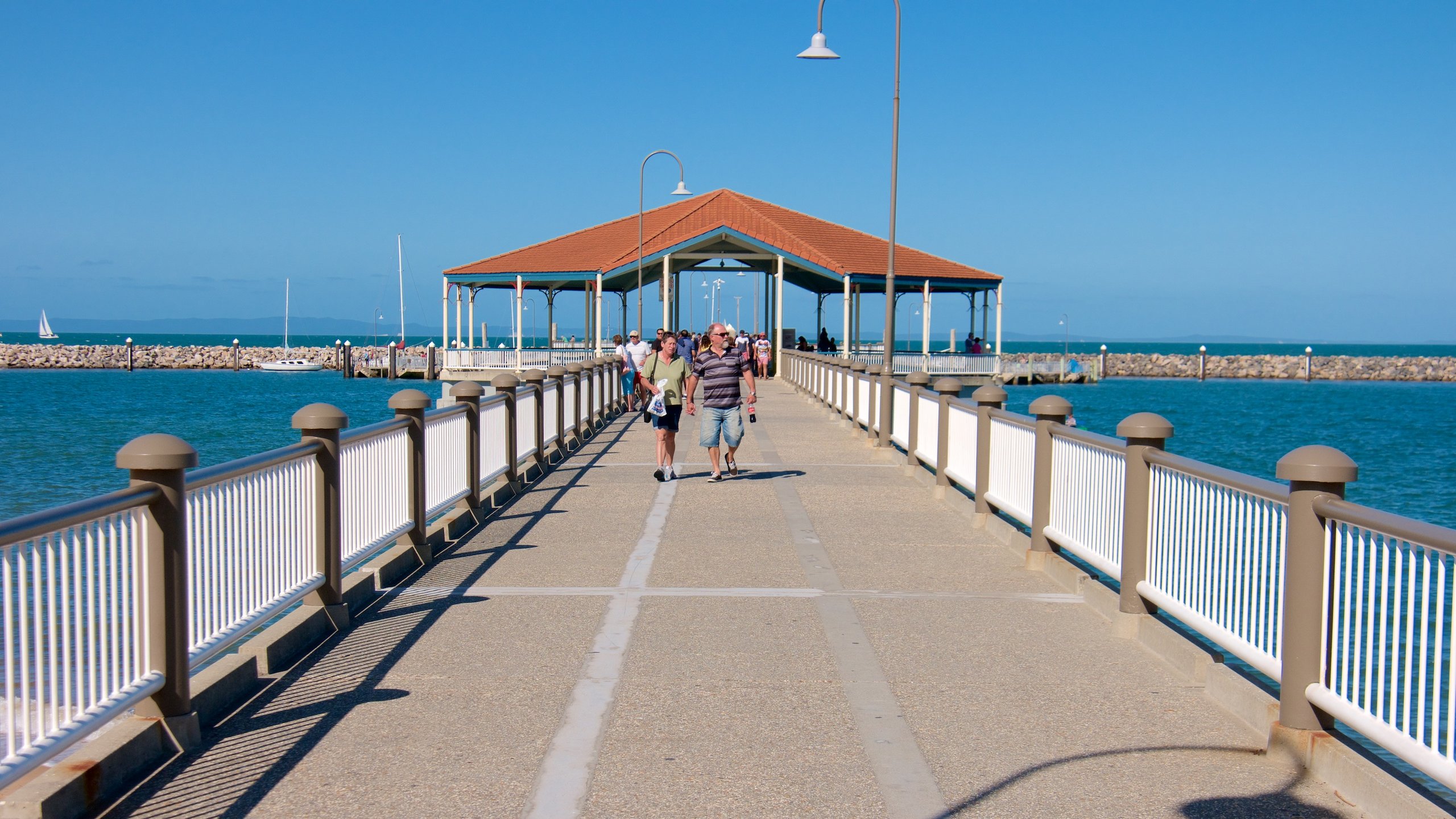 Redcliffe featuring general coastal views as well as a small group of people