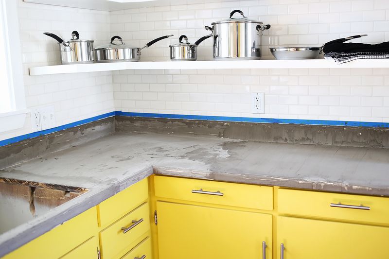 feather finish on countertop with painter's tape on white brick walls