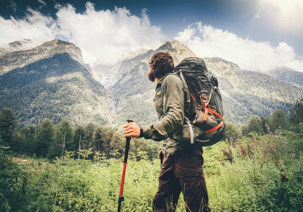 Backpacker admiring the view during a long trek in North America