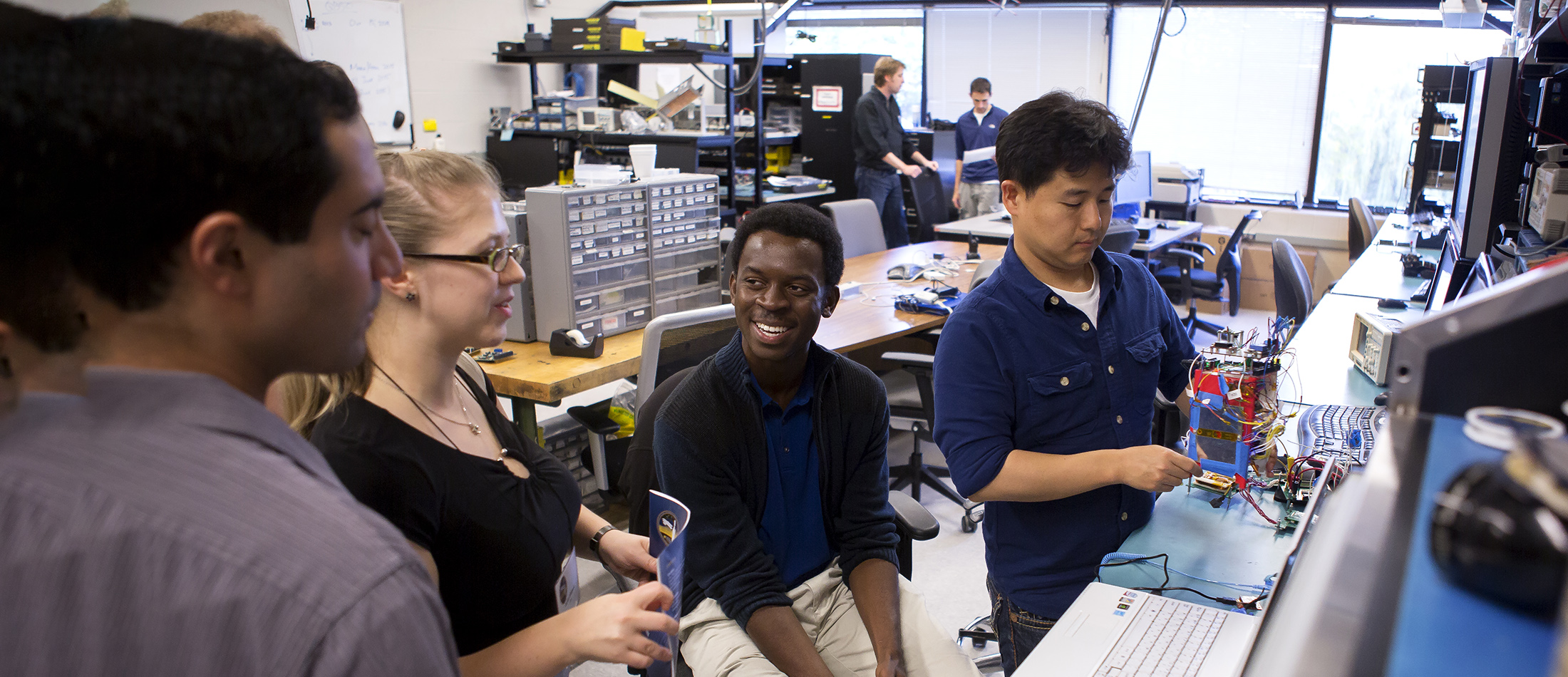 diverse students in aero lab interacting