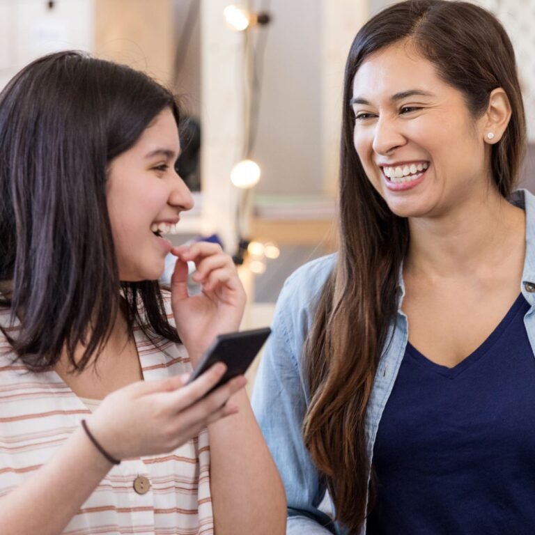 A girl and her aunt laughing