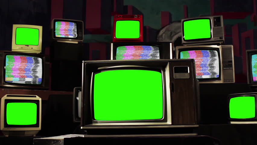 Six Old TVs Turning On Green Screens Among Many Retro Televisions with Color Bars. 4K Resolution.