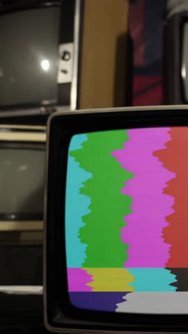 Vintage TV Displaying Green Chroma Key Surrounded by Antique Televisions - Vertical 4K, Ending with Zoom In on Screen