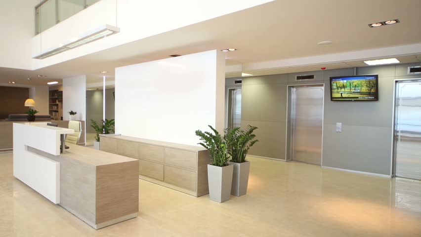 Front Desk In Reception Hall Anf Rest-room With Sofas At Business ...