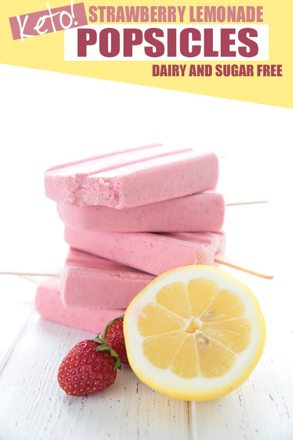 Keto Strawberry Popsicles in a stack with a lemon and some strawberries