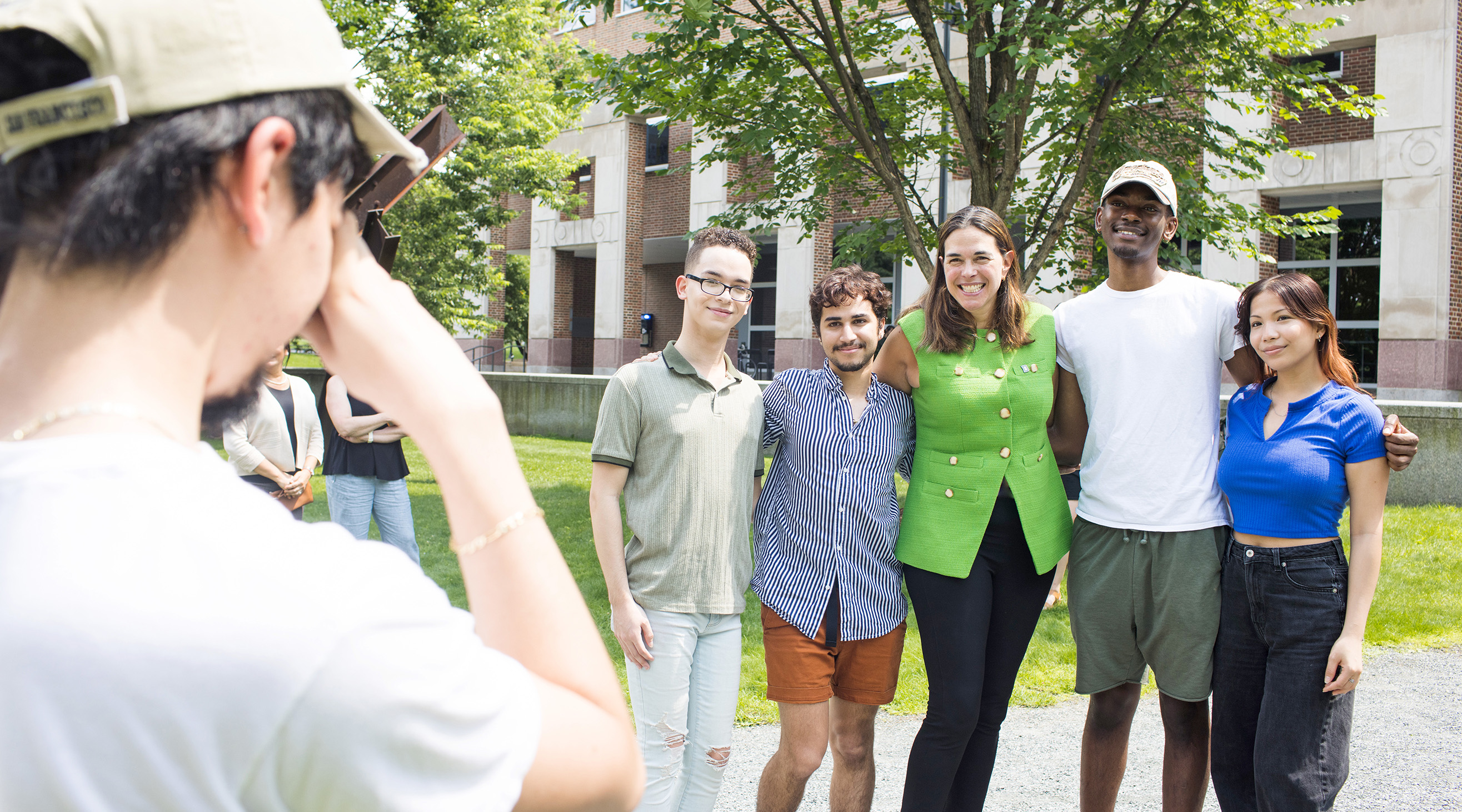 a diverse rgoup of students pose for a photo with President Beilock