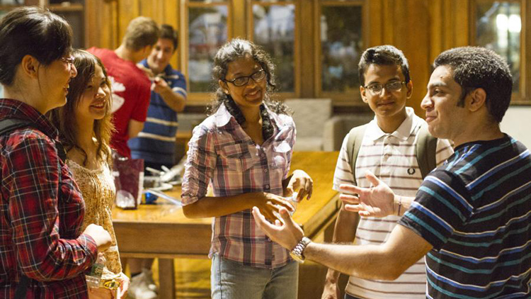 A group of international students in conversation in a classroom