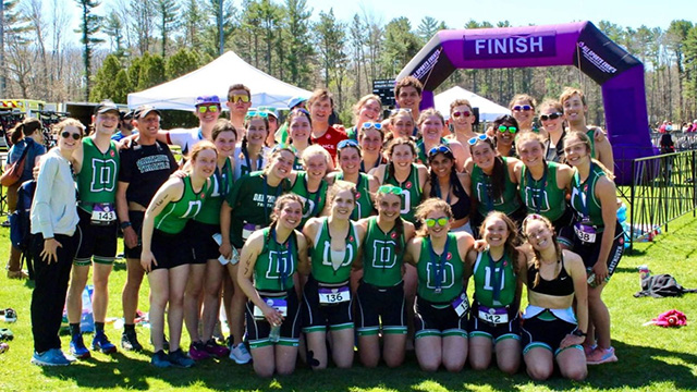 The triathlon team poses together after a competition