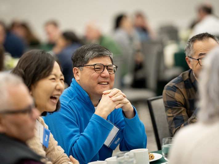 A group of parents laughing together at the Family Fellows 2024 event