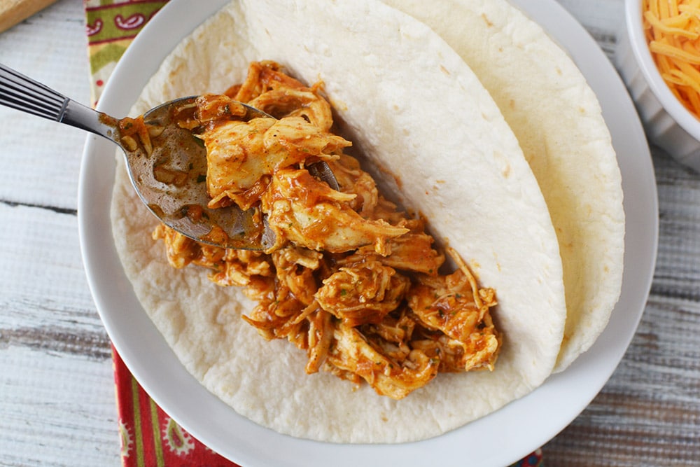 Chicken taco mixture into a tortilla. 