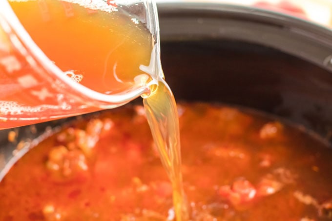 adding broth to crockpot