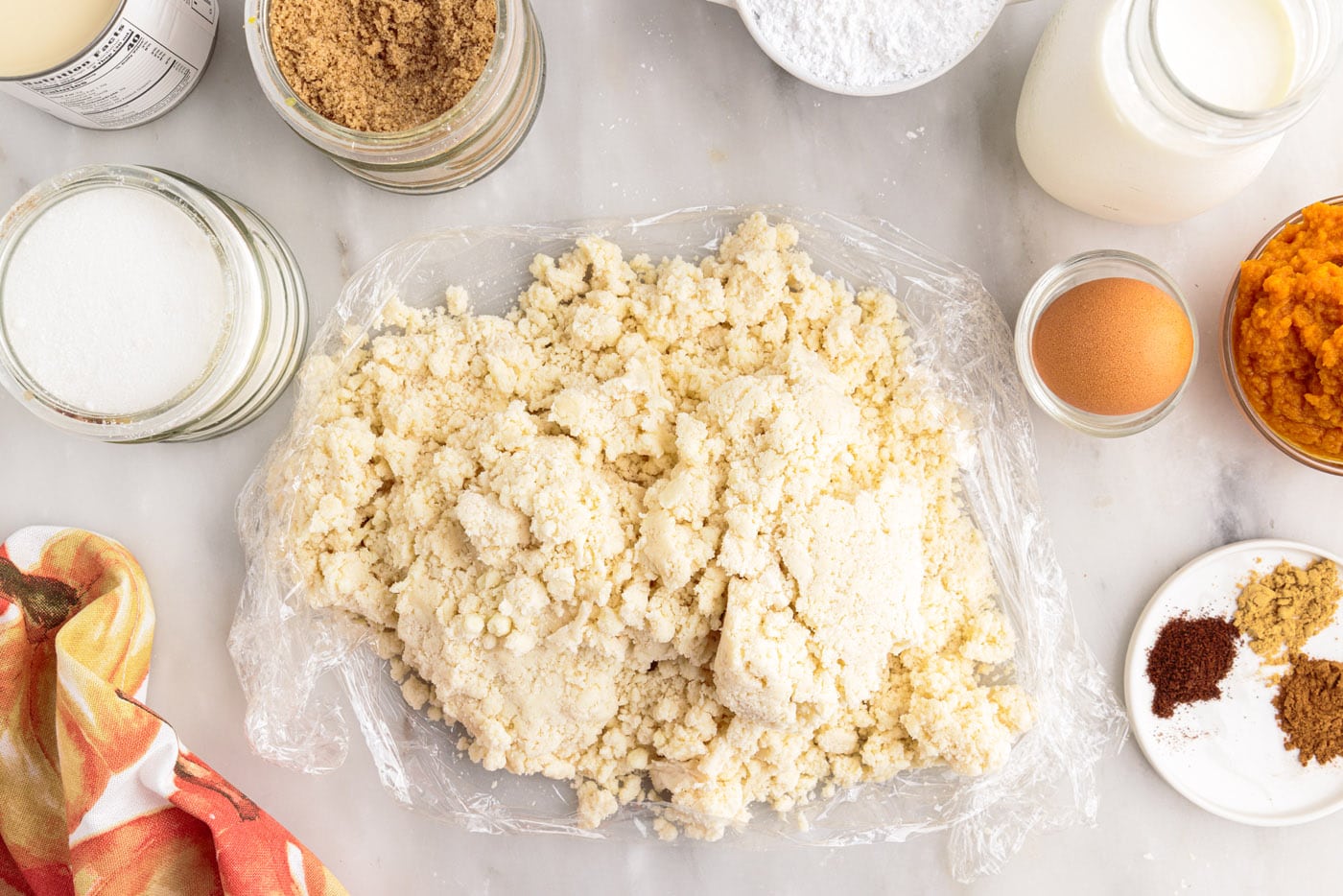 pie dough on top of plastic wrap