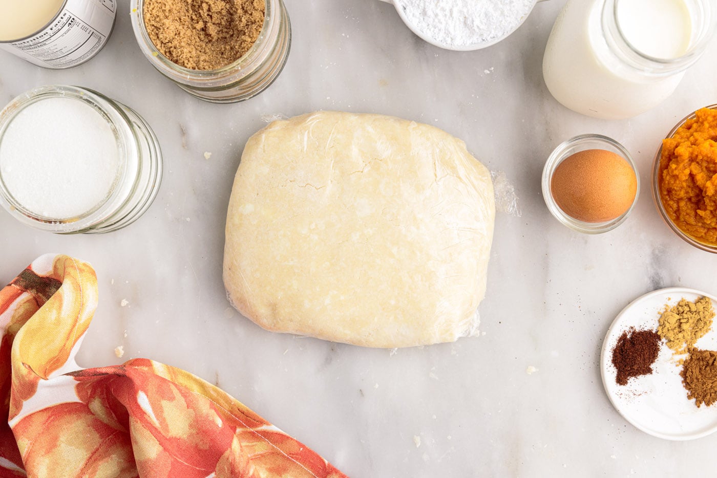 homemade pie dough wrapped in plastic wrap