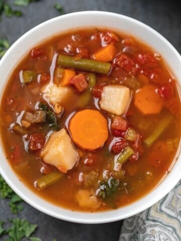 Bowl of Instant Pot Vegetable Soup next to instant pot.