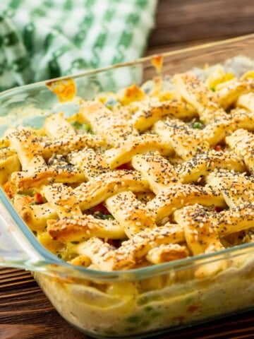 Baked Chicken Pot in glass baking dish with lattice biscuit topping.