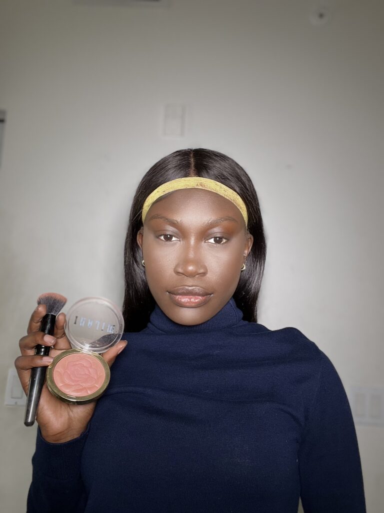 black woman using milani rose pink blush