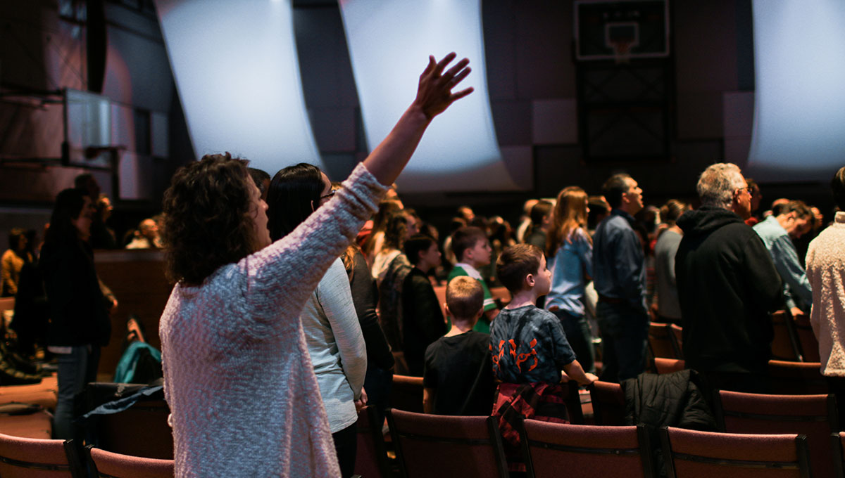 Woman raising her arm during worship