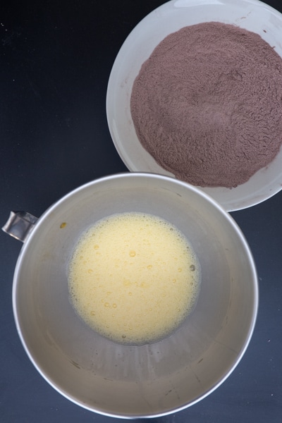 Eggs beaten and dry ingredients whisked in bowls.