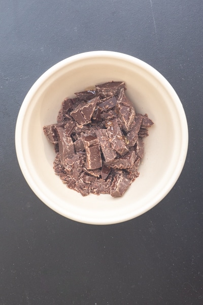 Chocolate pieces in a white bowl.