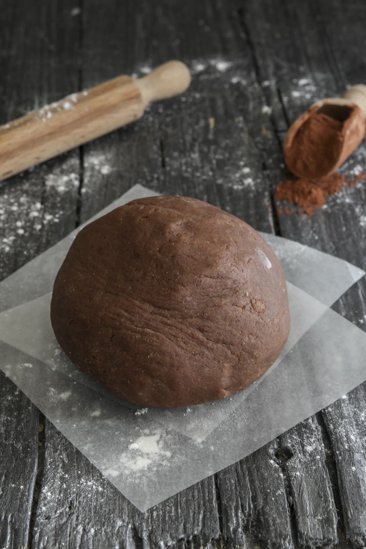 Chocolate pie dough on wax paper.