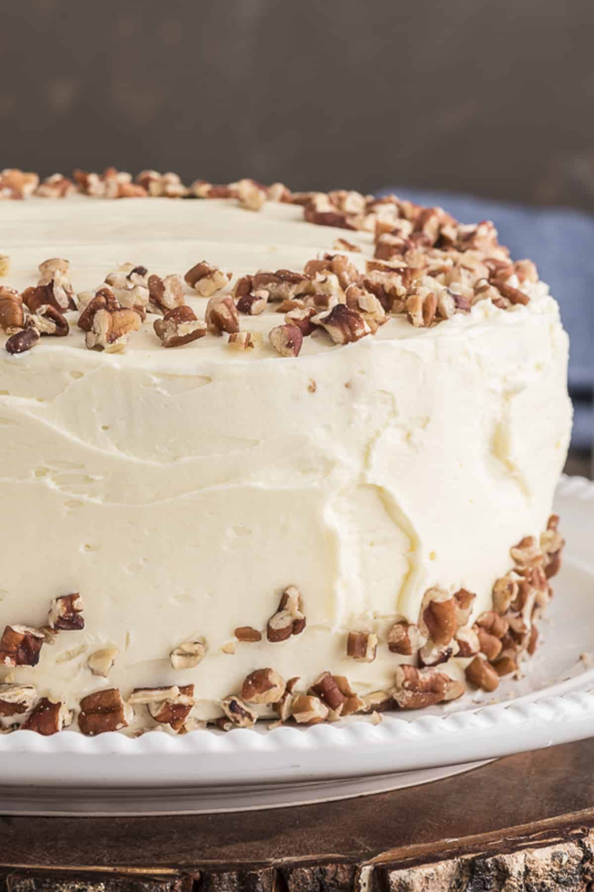 Carrot cake on a wooden stand.