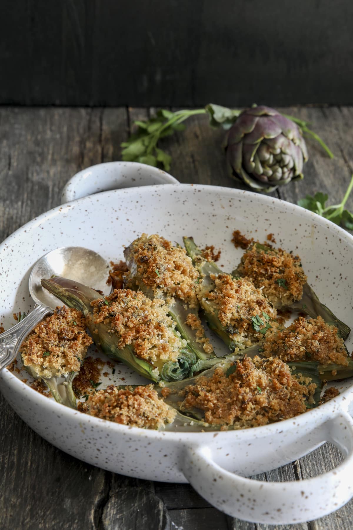 Baked artichokes in a white pan.