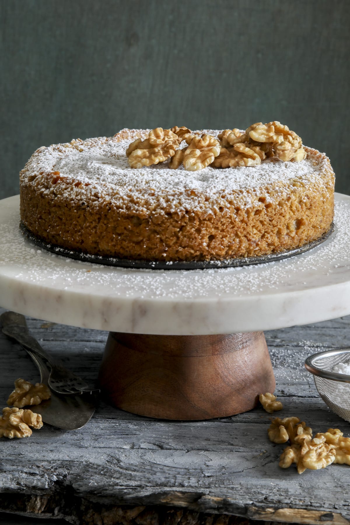 Nut cake on a white cake plate.