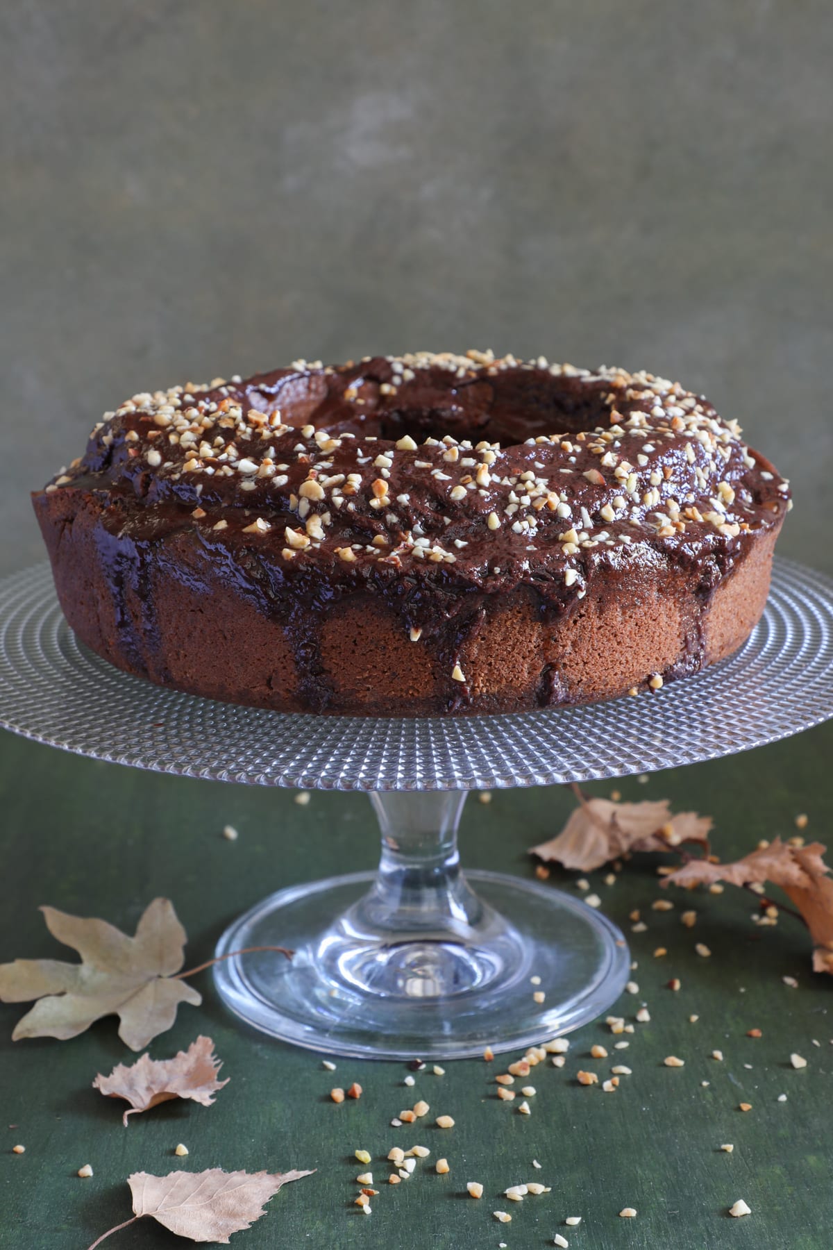 Rum cake on a glass plate stand.