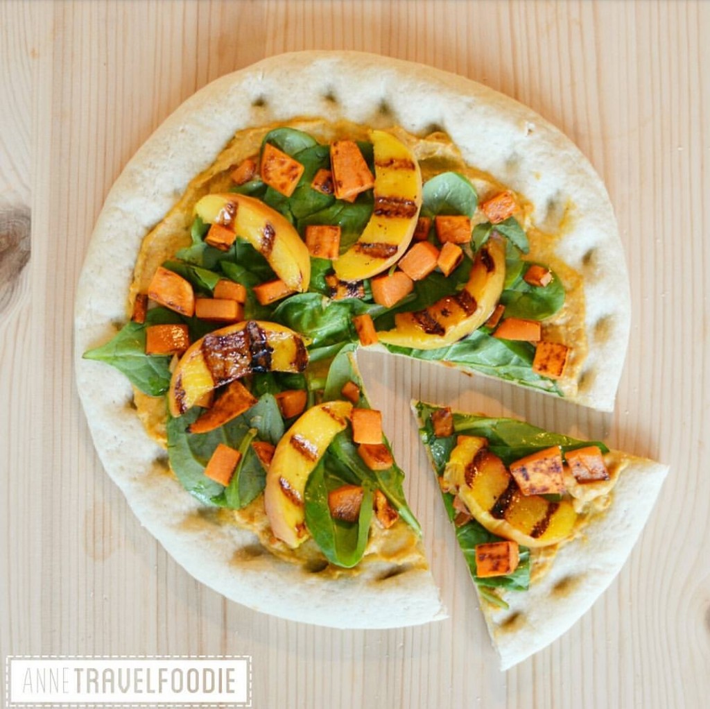 vegan cauliflower pizza with hummus and grilled peach