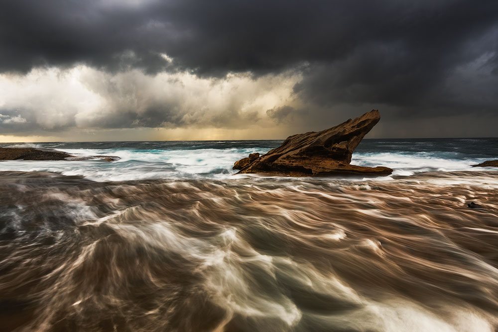 flowing receding wave moody ocean photo