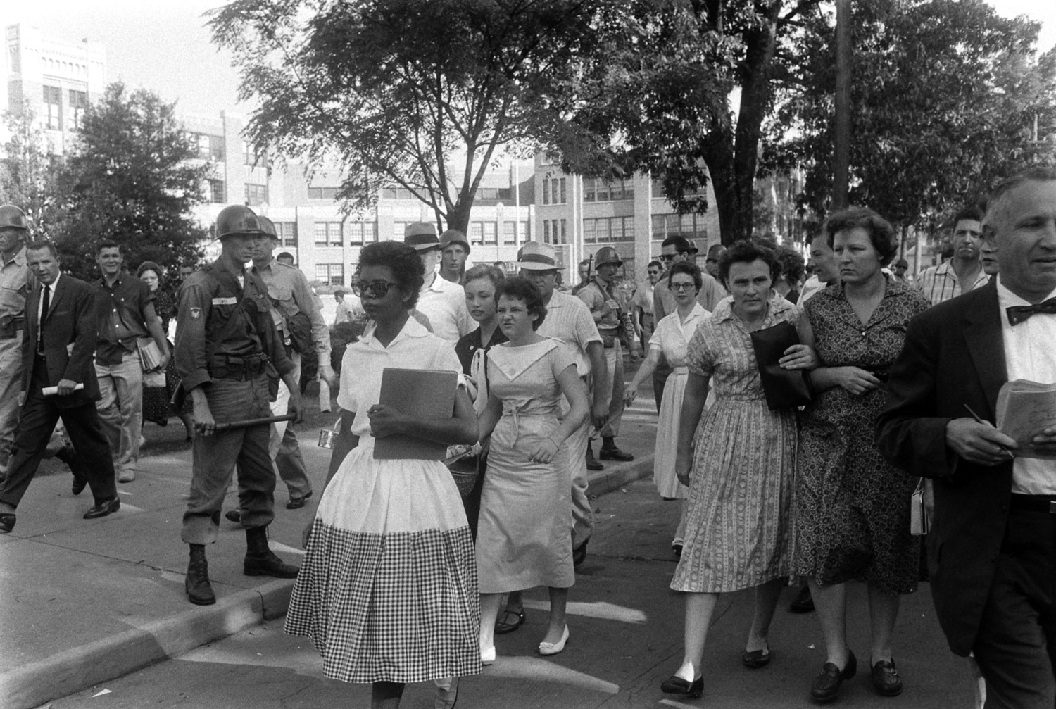 Hazel Bryant follows and jeers at Elizabeth Eckford as she walks from Little Rock's Central High after Arkansas National Guardsmen barred Eckford from school.