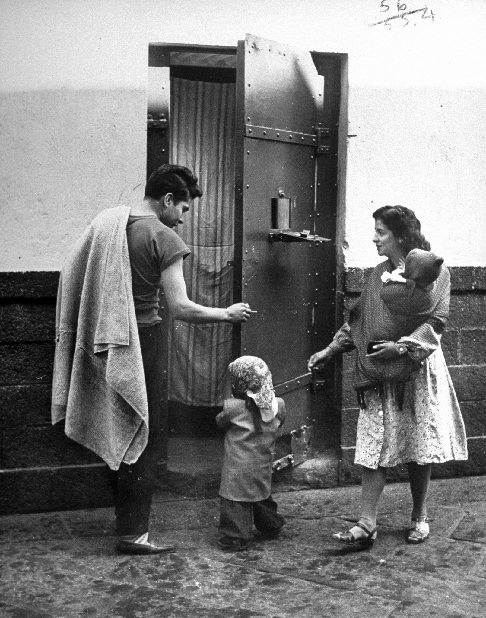 Family visit brings wife and two children to this man's cell. On a busy day the prison corridors and patios are filled with scores of scampering youngsters