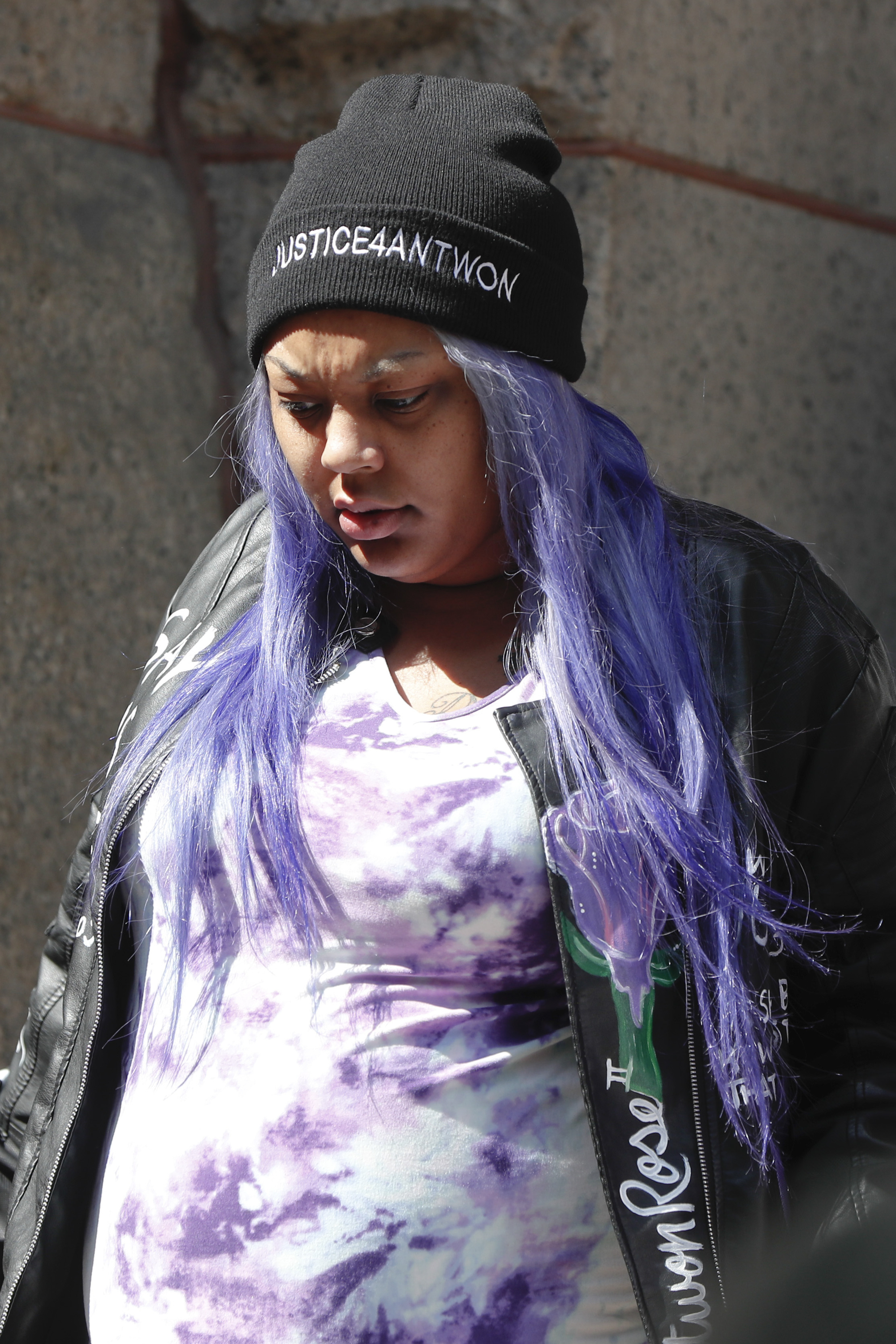 Kyra Jamison wears a hat embroidered with "Justice4Antwon" as she leaves the Allegheny County Courthouse with supporters for a lunch break on the first day of the trial for Michael Rosfeld, a former police officer in East Pittsburgh, Pa., on Tuesday, March 19, 2019, in Pittsburgh. Rosfeld is charged with criminal homicide in the fatal shooting of Antwon Rose II as he fled during a traffic stop on June 19, 2018. (AP Photo/Keith Srakocic)