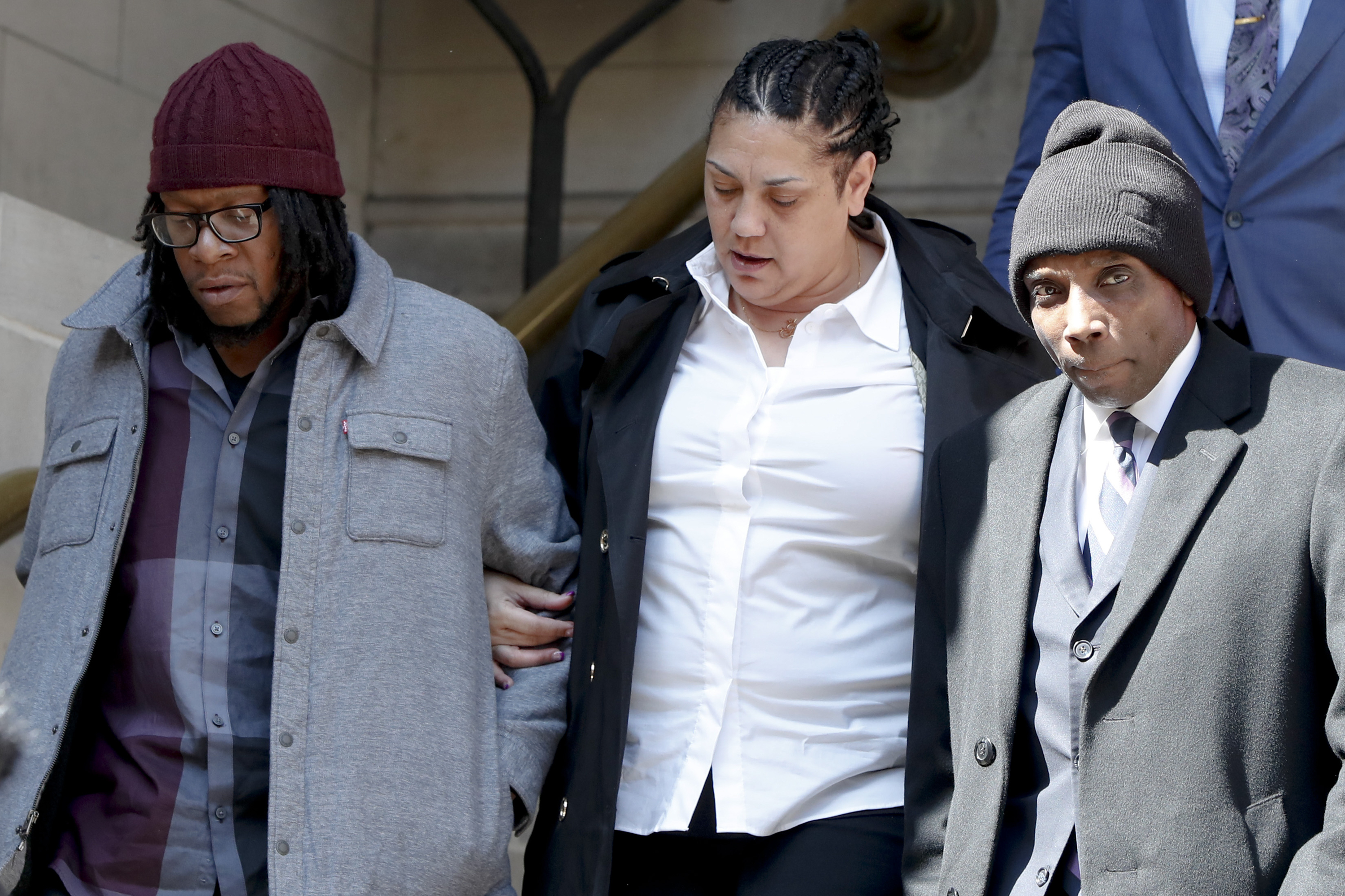 Michelle Kenney, center, the mother of Antwon Rose II, leaves the Allegheny County Courthouse with supporters for a lunch break on the first day of the trial for Michael Rosfeld, a former police officer in East Pittsburgh, Pa., on Tuesday, March 19, 2019, in Pittsburgh. Rosfeld is charged with criminal homicide in the fatal shooting of Antwon Rose II as he fled during a traffic stop on June 19, 2018. (AP Photo/Keith Srakocic)