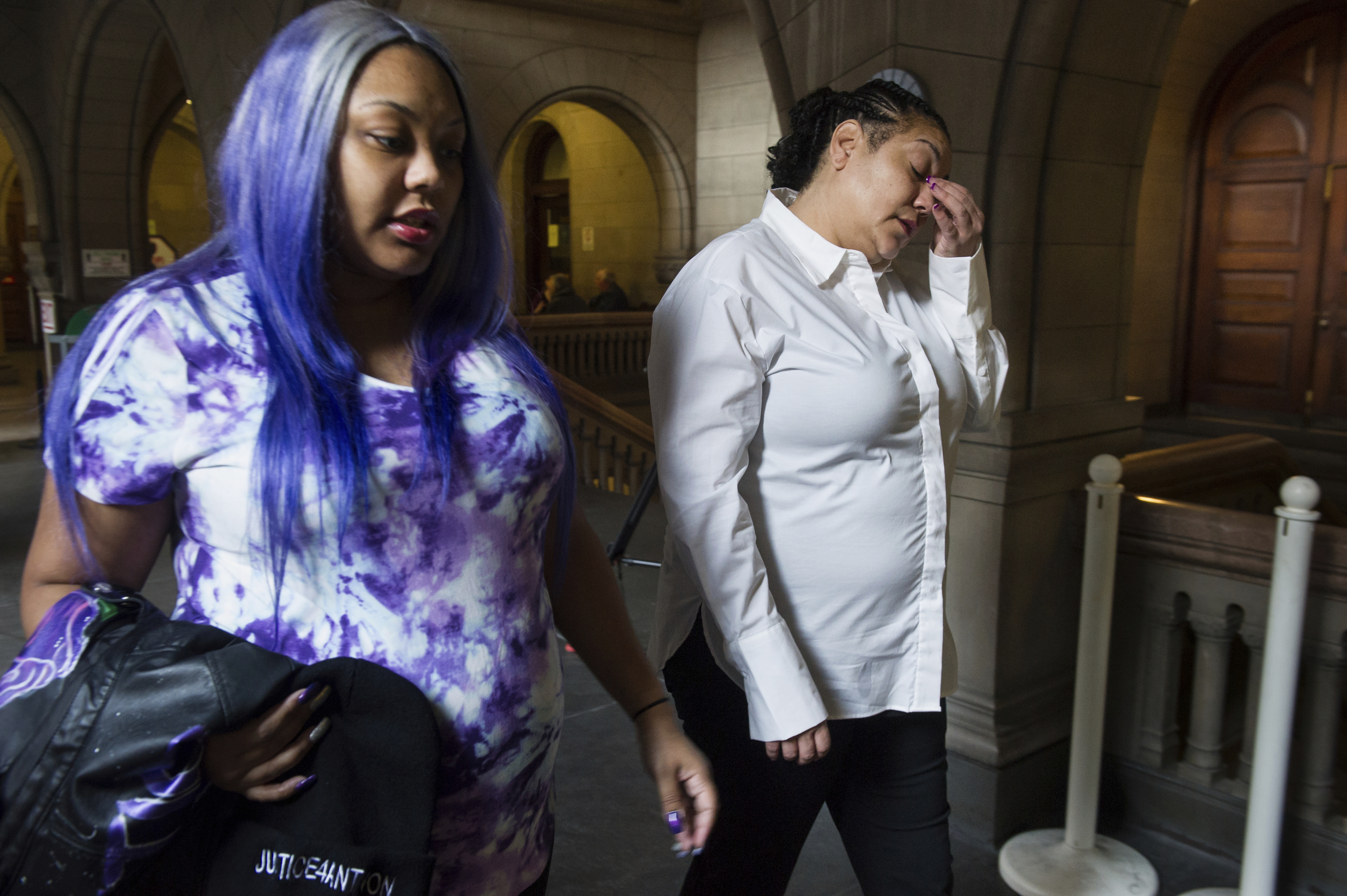 Kyra Jamison, left, and Michelle Kenney, right, sister and mother of Antwon Rose II, arrive for the first day of the homicide trial of former East Pittsburgh police officer Michael Rosfeld, Tuesday, March 19, 2019, at the Allegheny County Courthouse in Pittsburgh. A white police officer who shot and killed an unarmed black 17-year-old in 2018 goes on trial starting Tuesday. Lawyers for Rosfeld, 30, are expected to argue that the June shooting of Rose after a traffic stop in East Pittsburgh was justified. Prosecutors say Rosfeld, who is charged with criminal homicide, gave inconsistent statements about whether he believed Rose had a gun.(Stephanie Strasburg/Pittsburgh Post-Gazette via AP, Pool)