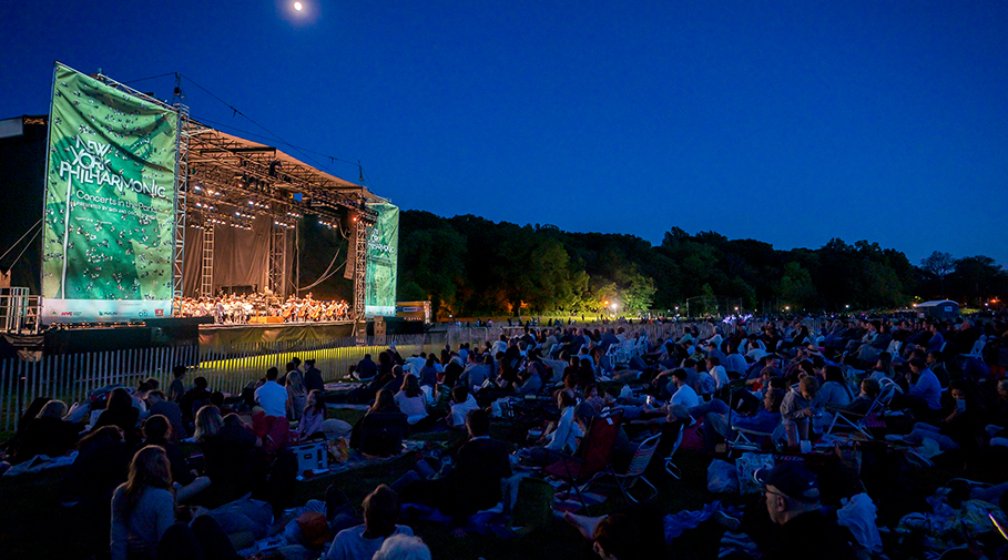 Photo of audience and orchestra at a Concerts in the Parks event.